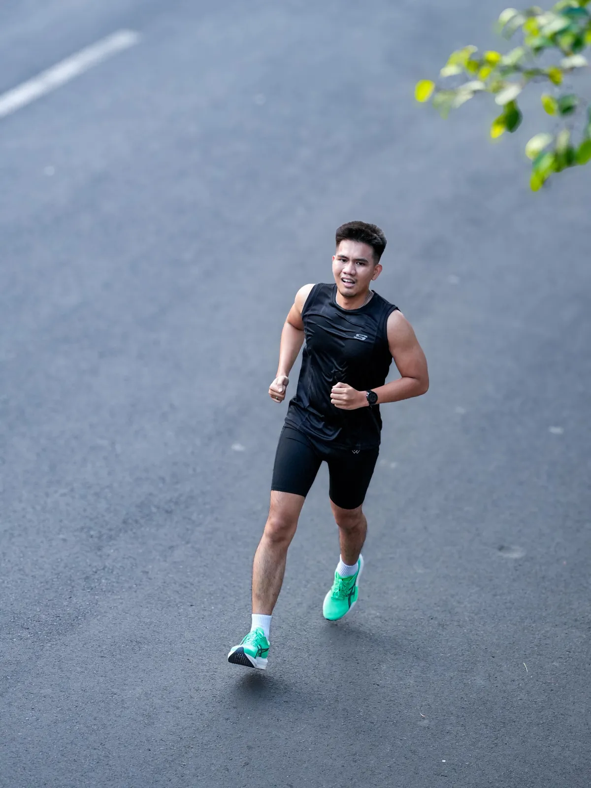 Authentic Indonesian runner catching breath after finishing race